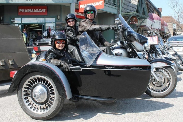 A man with 2 children on a motorcycle